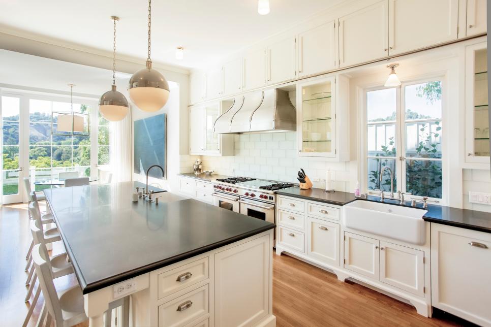 Traditional Kitchen With White Cabinets and Black Countertops
