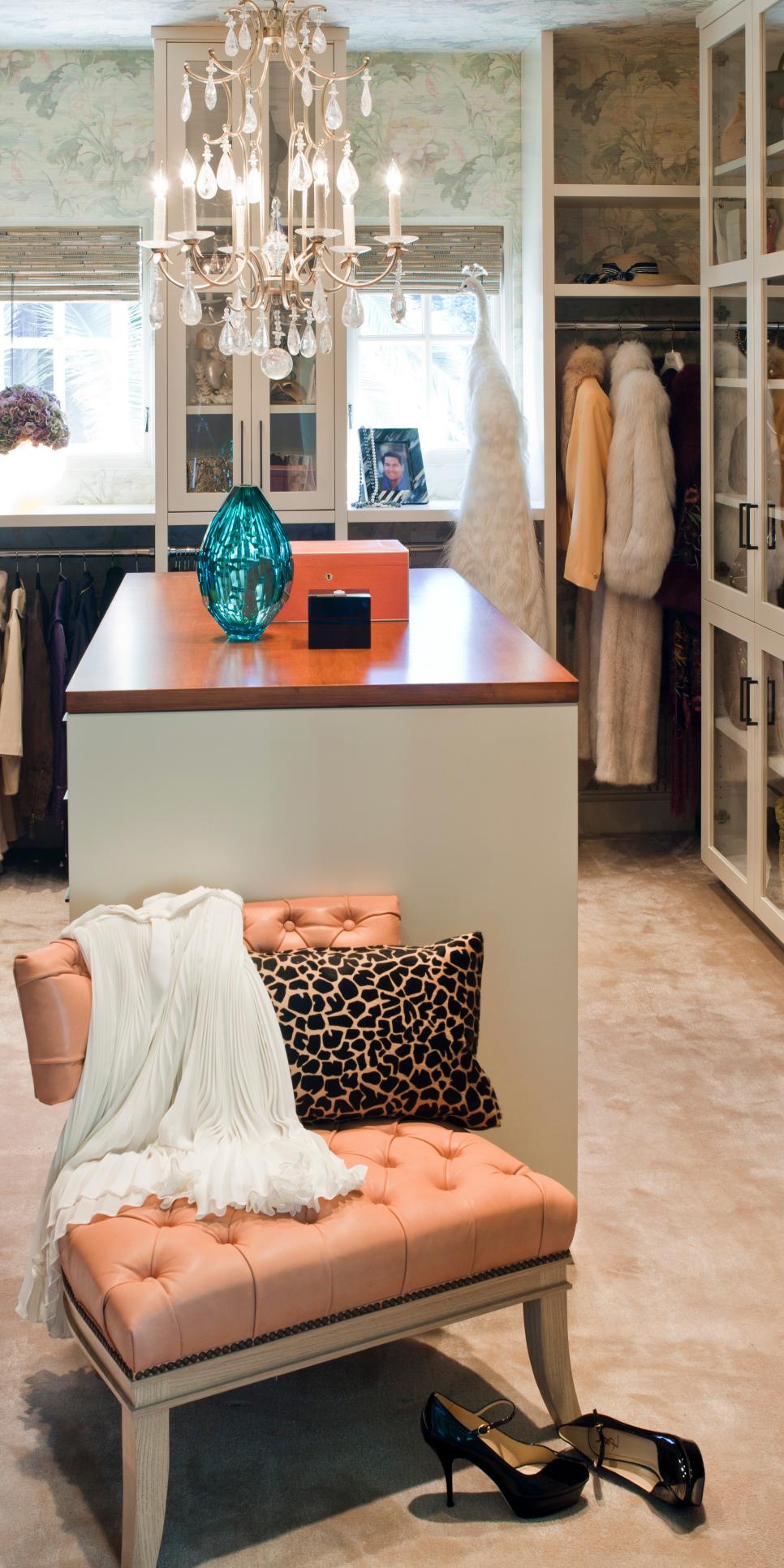Elegant Walk-In Closet With Salmon Tufted Chair Walk-In Closet With Elegant Chandelier and Peach Upholstered Chair