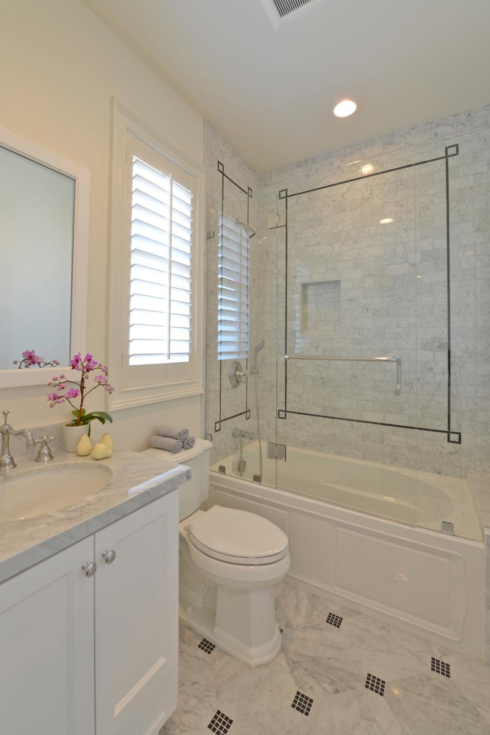 Traditional Neutral Bathroom With Carrara Marble Tile Shower Traditional Bathroom With White Vanity and Gray Marble Accents