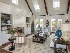Vaulted ceilings and walls of windows define the home's central gathering space, where coastal elegance makes a sophisticated design statement.