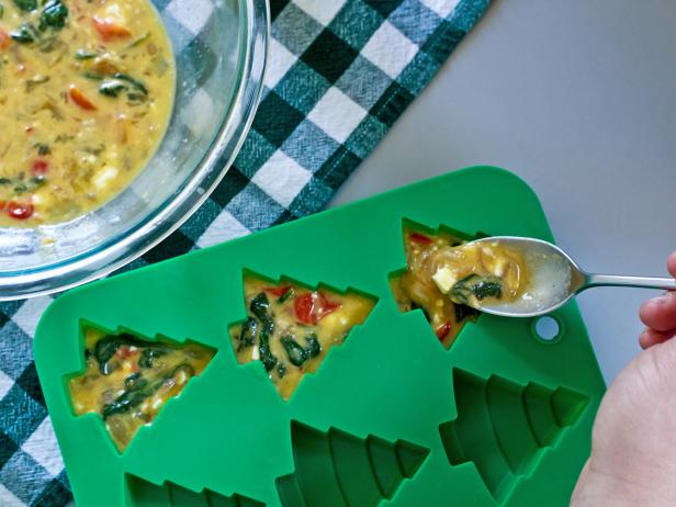 Pour spinach and egg mixture into Christmas tree-shaped molds to make a holiday-inspired frittata breakfast.
