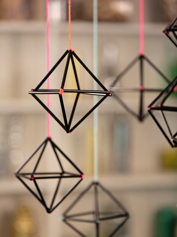 Use black plastic straws and colorful yarn to create a simpler, sturdier version of Finnish Himmeli ornaments, which are traditionally made from straw. Hang a bunch together for a modern, graphic holiday centerpiece.