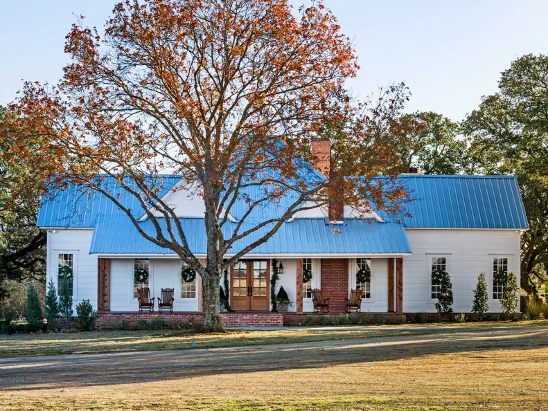 farm house with metal roof and large land