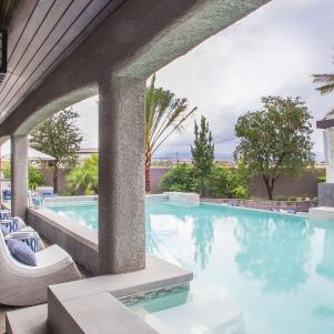 White Outdoor Rocking Chairs Next to Contemporary Pool