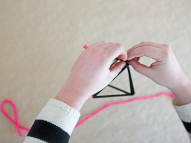 Step 7: Using a second length of string, tie the two side triangles together underneath to finish the diamond shape.