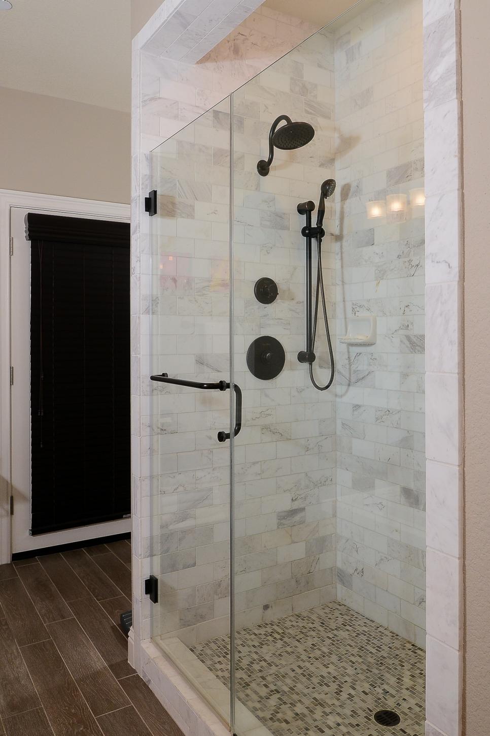 Timeless Glass-Enclosed Shower With Marble Tile Glass-Enclosed Shower With Marble Tile and Bronze Fixtures
