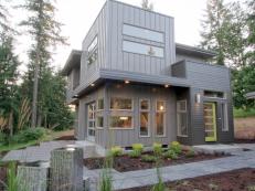 Exterior View of Modern Gray Home With Stone Tile Walkway