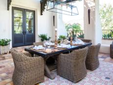 Mediterranean Patio With Dining Table and Brown Chairs