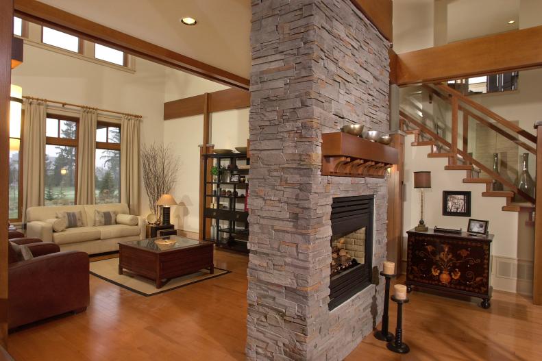 Free-Standing Stacked-Stone Fireplace in Neutral Living Room