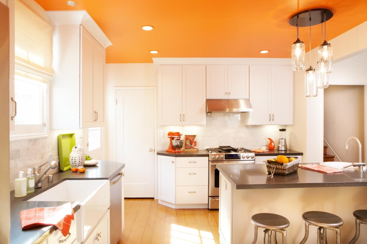 orange kitchen wall with white cabinet