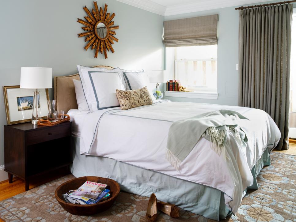 Blue Transitional Bedroom With Patterned Area Rug and Brown Accents