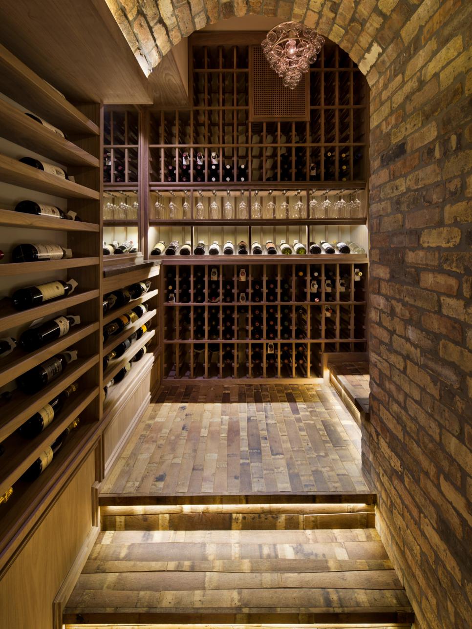 Shelf and stair lights illuminate the wine cellar.