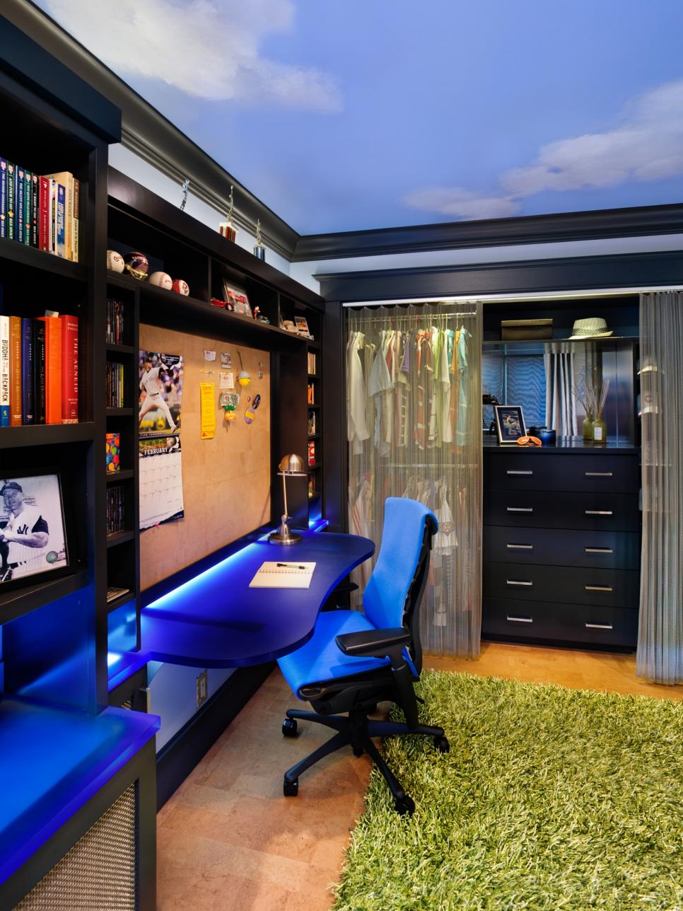 Boy's Bedroom With Black Built-In Shelves, Blue Desk and Black Dresser