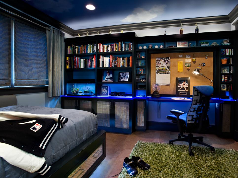 Boy's Blue Bedroom With Built-In Bookshelf and Black Desk