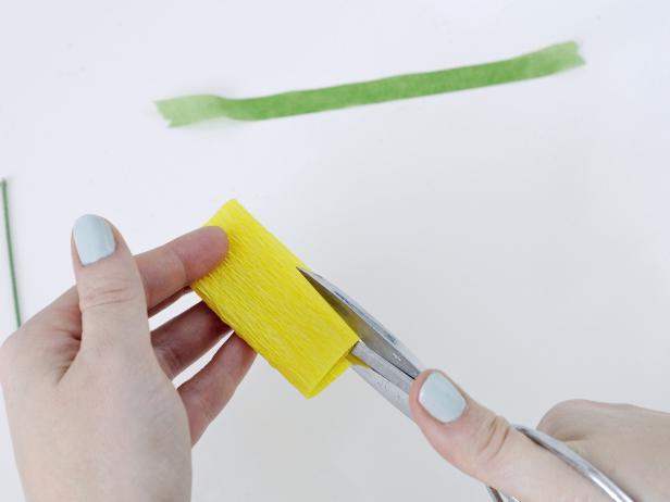 Cut slits into the top 1 1/2 inches of the folded crepe paper to create fringe.