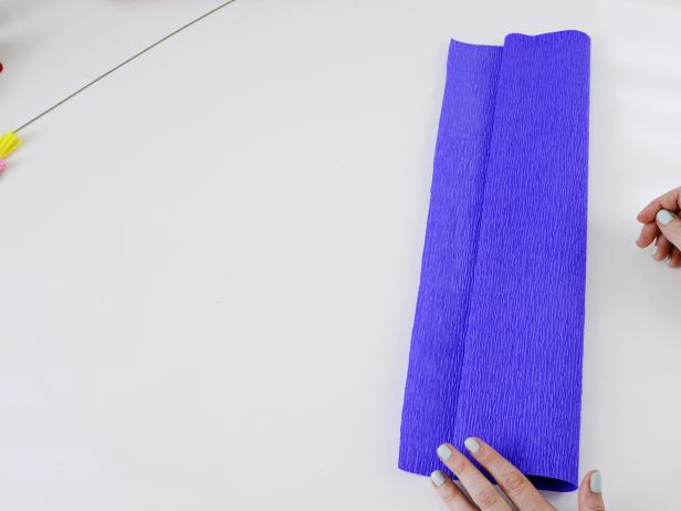 Cut a 24-inch piece of crepe paper, and fold the edge in 4 inches (image 1). Continue to fold the crepe paper until it meets the other end.