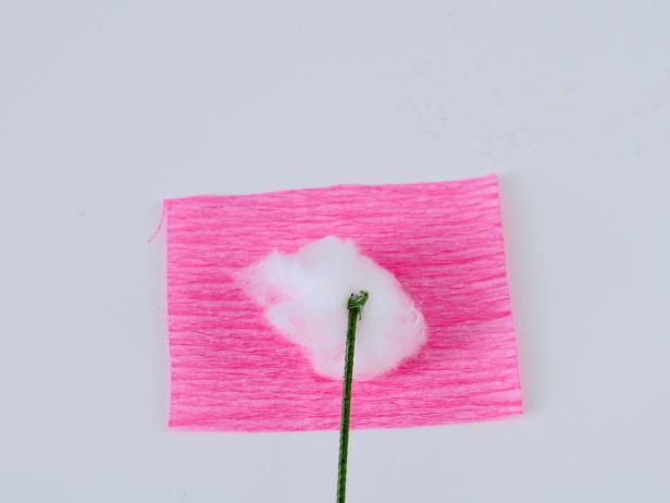 To make the peony, roll a medium-sized piece of cotton into a ball. Cut a 2x2-inch piece of pink crepe paper.