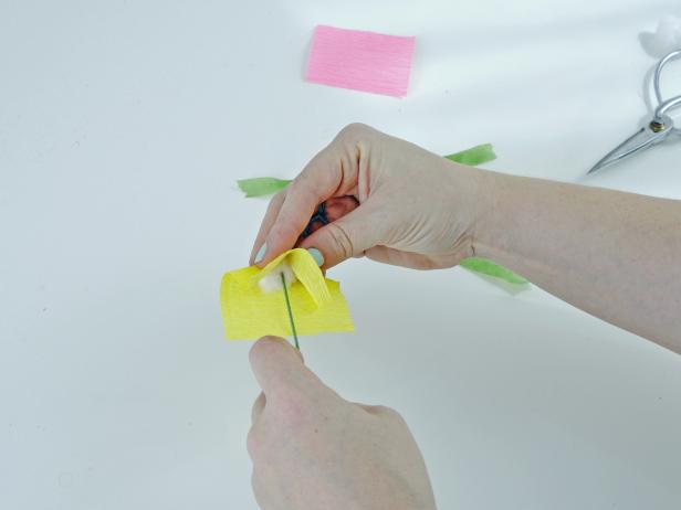 Twist the edges of the crepe paper around the wire, and use floral tape to secure.
