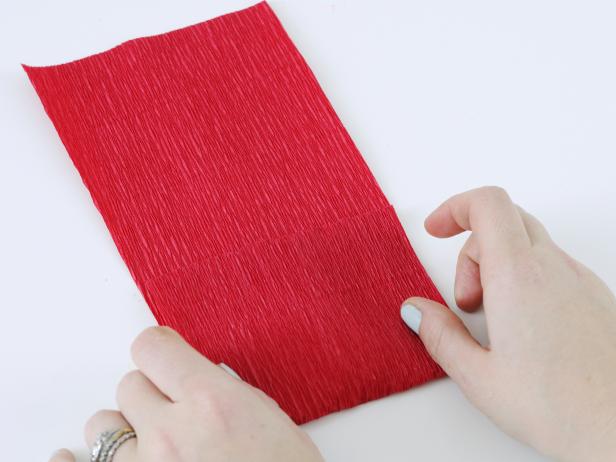 To make the tulip petals, cut a 4-inch wide strip of crepe paper. Fold the edge of the strip up 4 inches