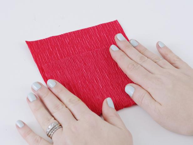 To make the tulip petals, cut a 4-inch wide strip of crepe paper. Fold the edge of the strip up 4 inches.