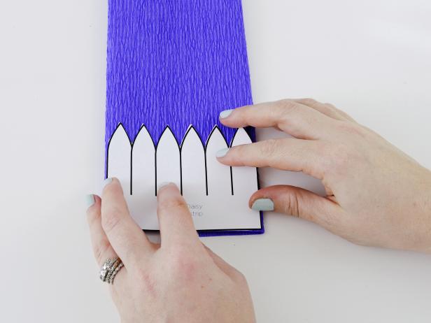 Print out the daisy template, and match the bottom edge with the bottom edge of the folded crepe paper.