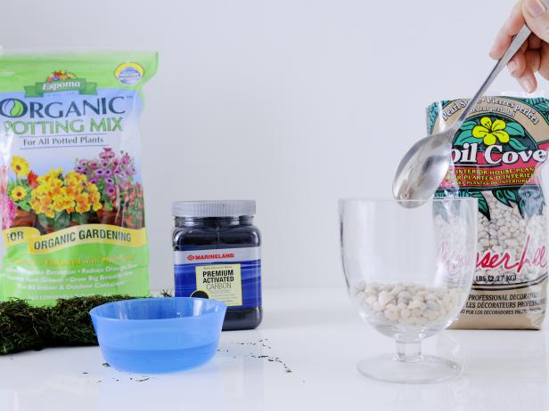 To make your terrarium, start with a one to two inch layer of any color decorative rock to ensure proper drainage.