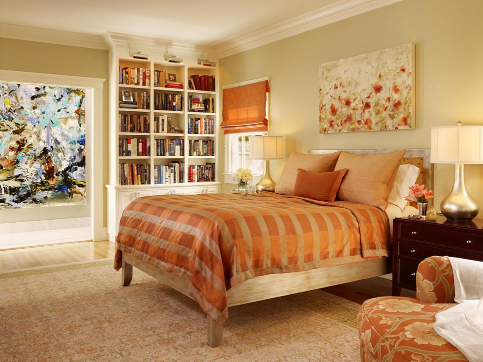 Transitional Orange and Gold Master Bedroom With Built-In Bookshelf