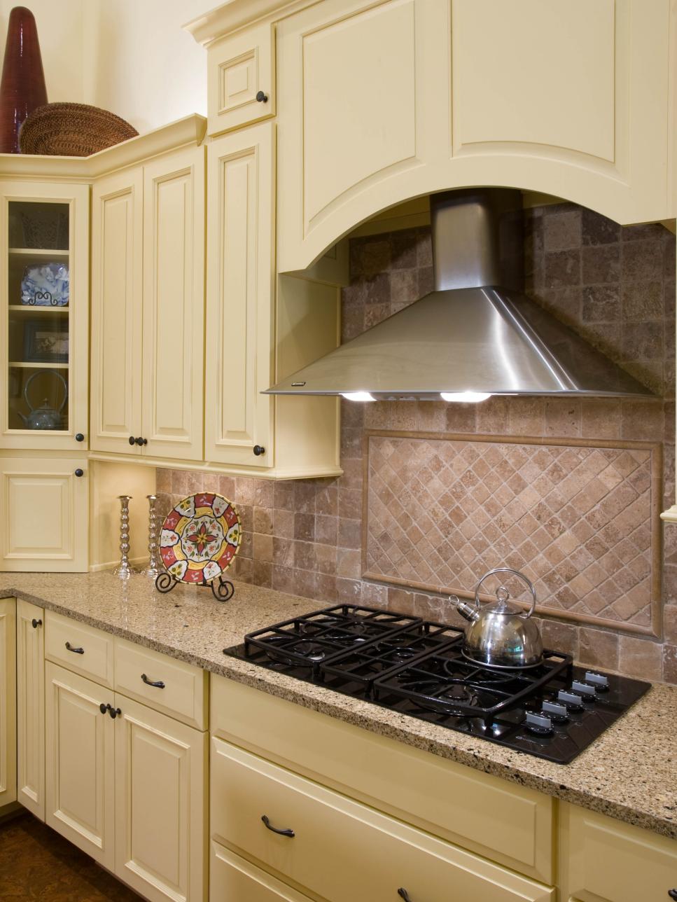 Stainless Steel Range Hood With Cream-Colored Cabinets