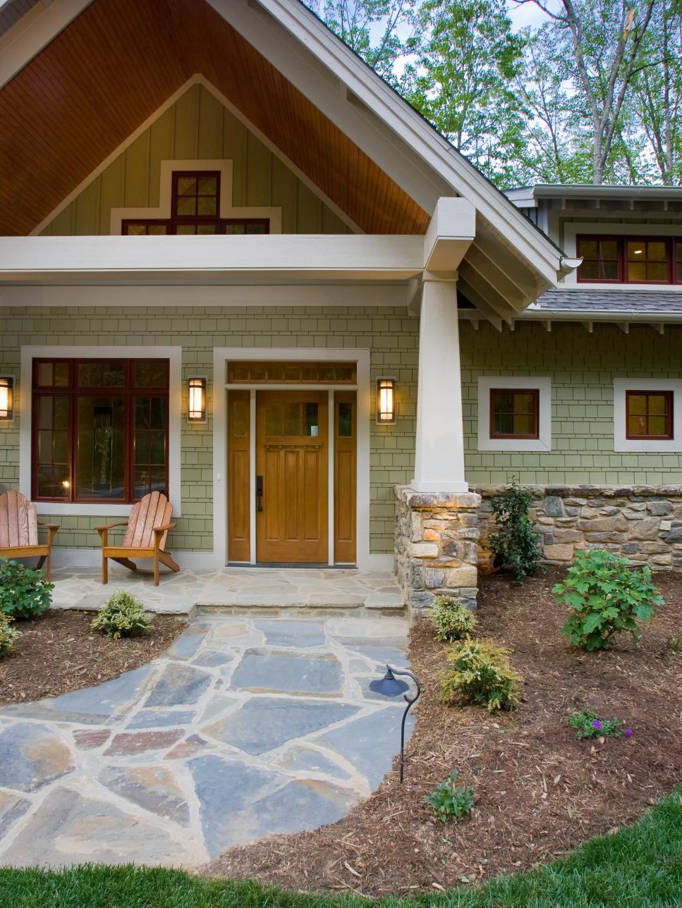 Craftsman-Style Home With Green Siding and Stone Walkway