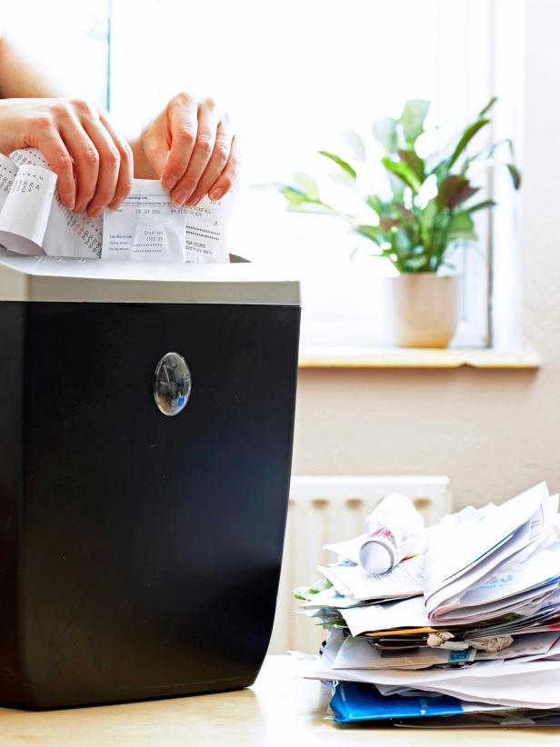 Woman Shredding Receipts From Paper Stack Woman Shredding Receipts From Paper Stack