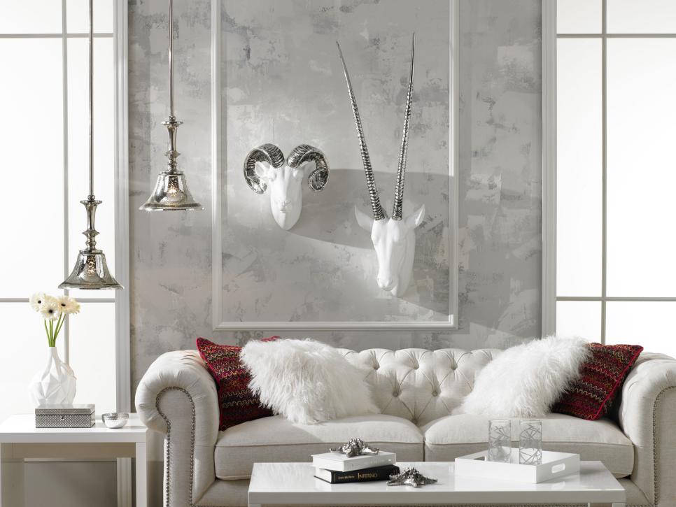 Contemporary Living Room With Faux Animal Heads Contemporary Living Room With White Sofa and Metallic Pendants