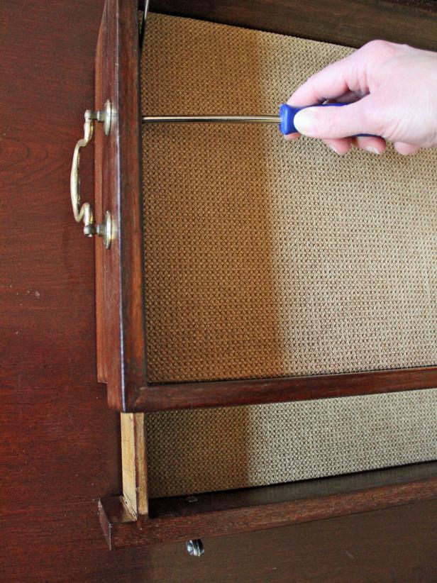 Pop re-covered liners into box then reattach hardware into the newly stained cutlery-turned-jewelry box with a screwdriver.
