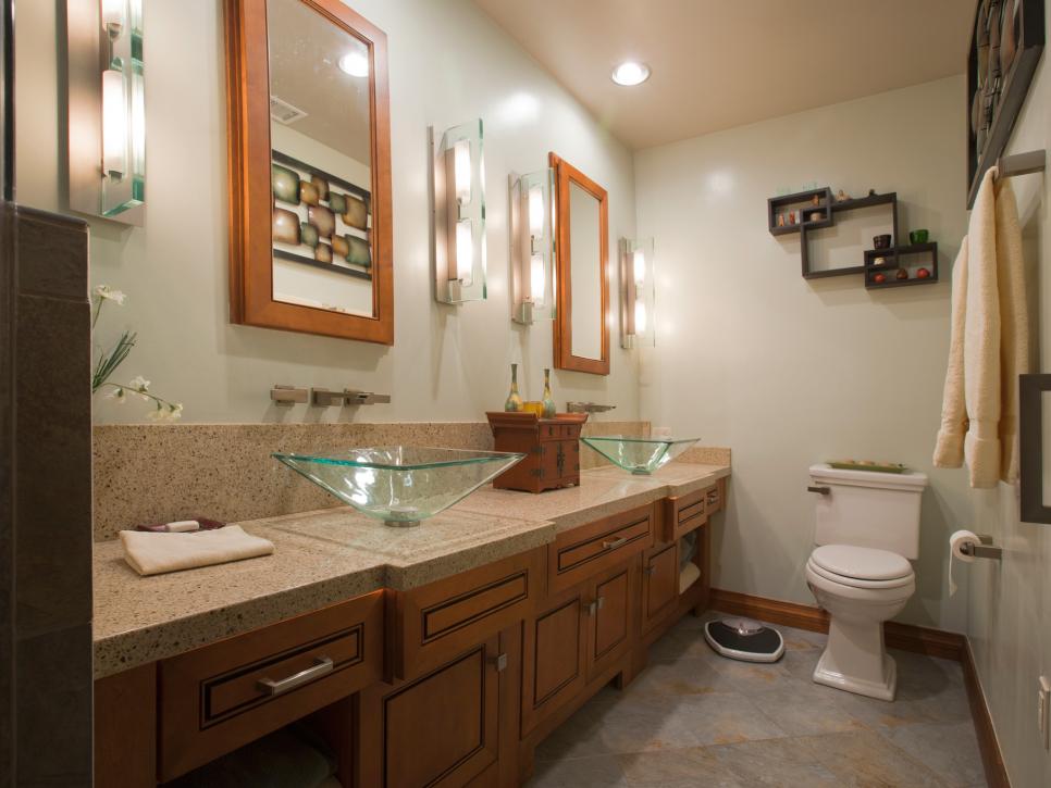Green Glass Vessel Sinks Atop a Bathroom's Granite Countertop