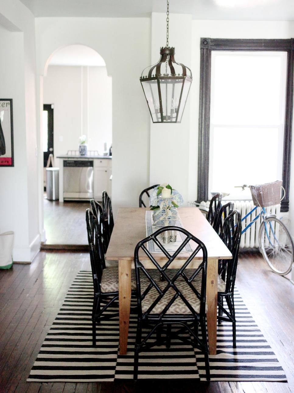 Eclectic Dining Space With Black Chairs and Farm Table