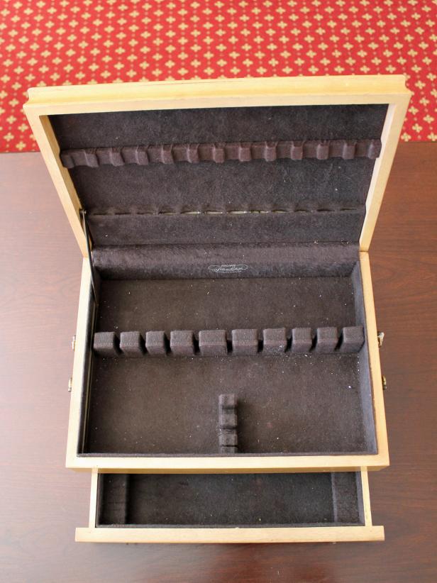 The old cutlery box was a steal at just $9 but the decades-old blond finish and felt-lined interior were in poor condition
