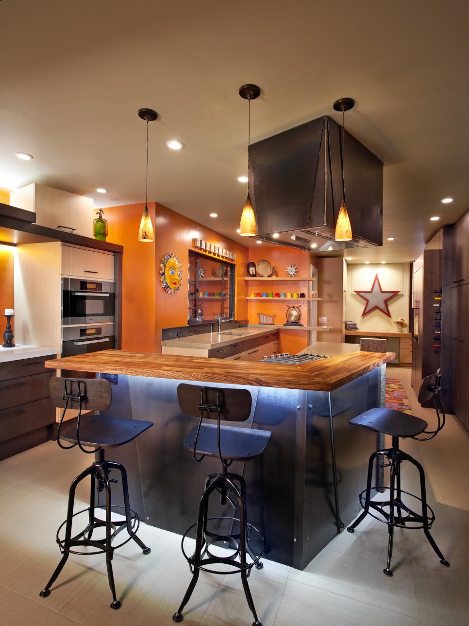Eclectic Kitchen With Orange Accent Wall and Industrial Cabinetry