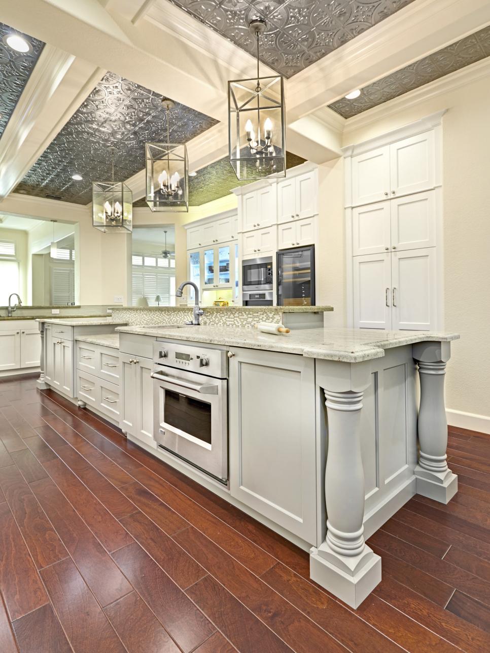 White Kitchen With Large Island and Tin Ceiling