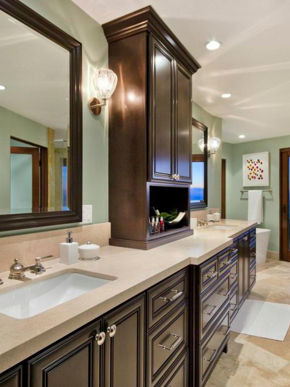 Light Blue Bathroom With Dark Cabinets and Freestanding Tub