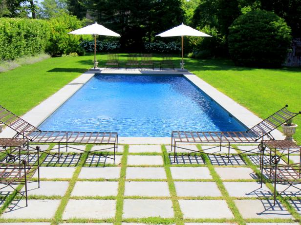 Traditional Backyard With Swimming Pool and Lounge Chairs