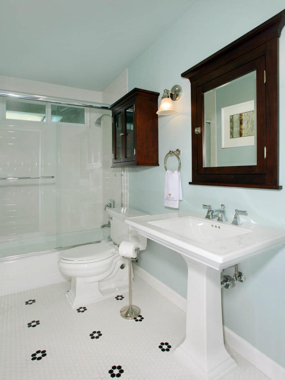 Light Blue Bathroom With Pedestal Sink and White Tile Floor