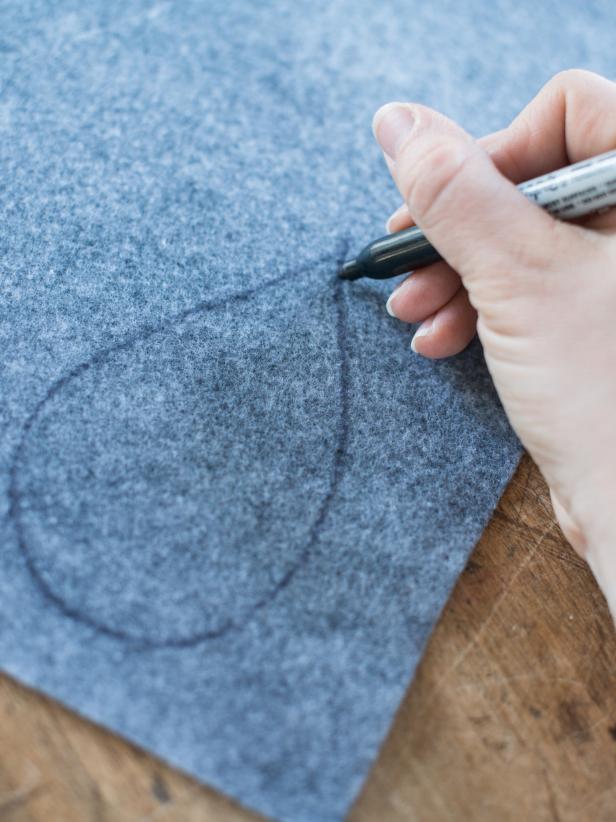 Using a permanent marker, draw a teardrop shape about 4" long on the medium gray felt then cut out.