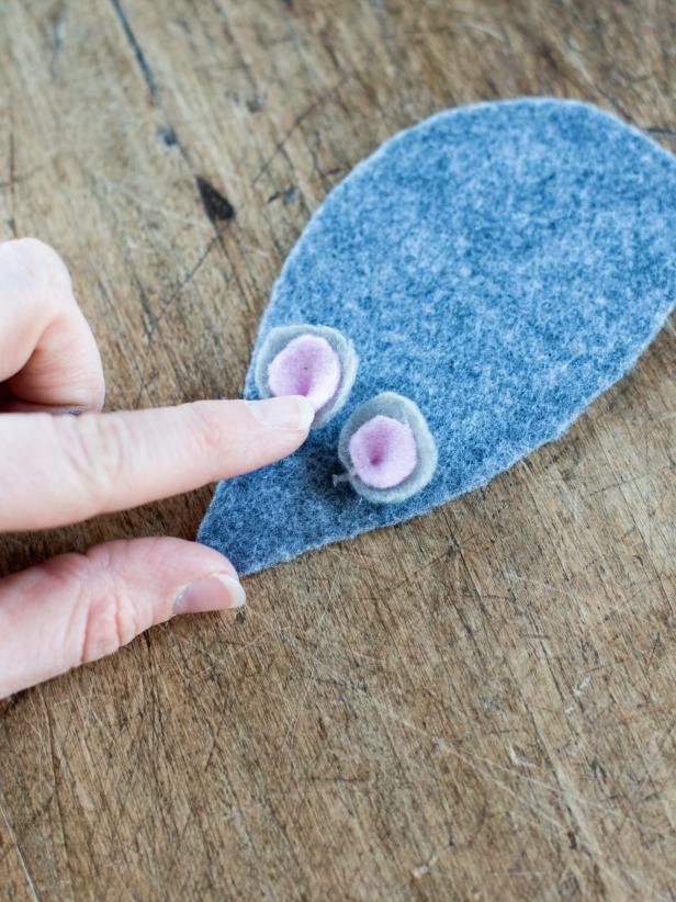 Use all-purpose, fabric or hot glue gun to attach ears, nose and eyes to felt mouse body.