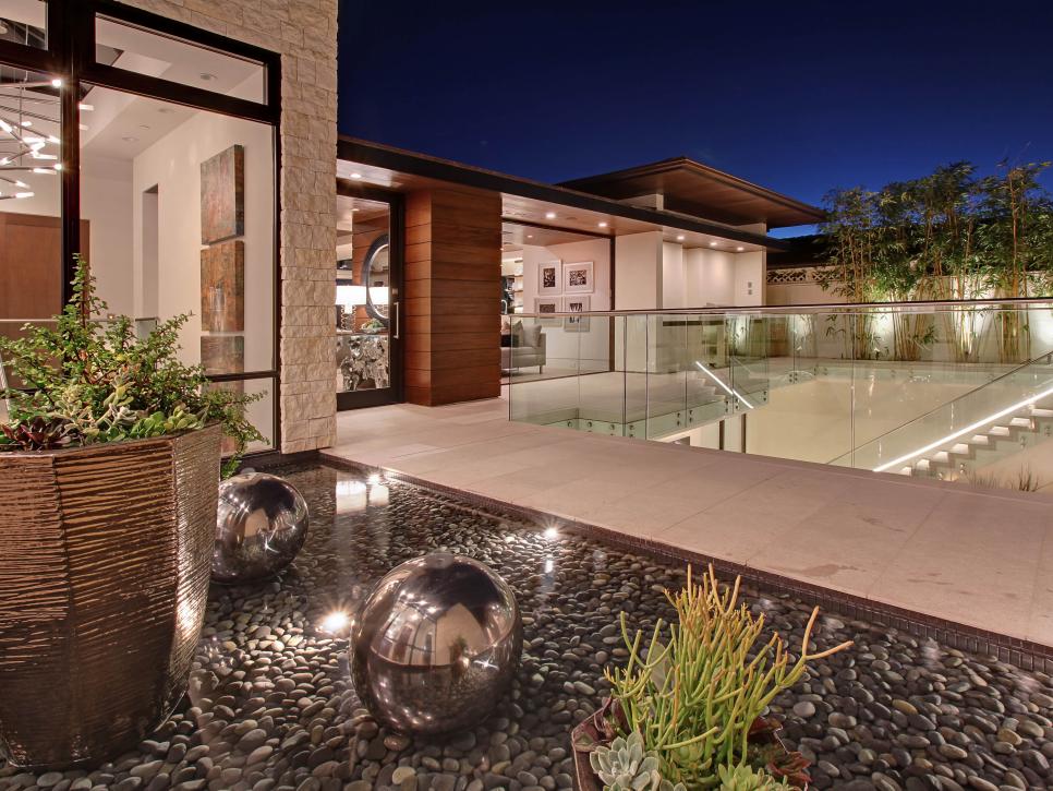 Outdoor Atrium with Rock Beds and Metallic Garden Accents