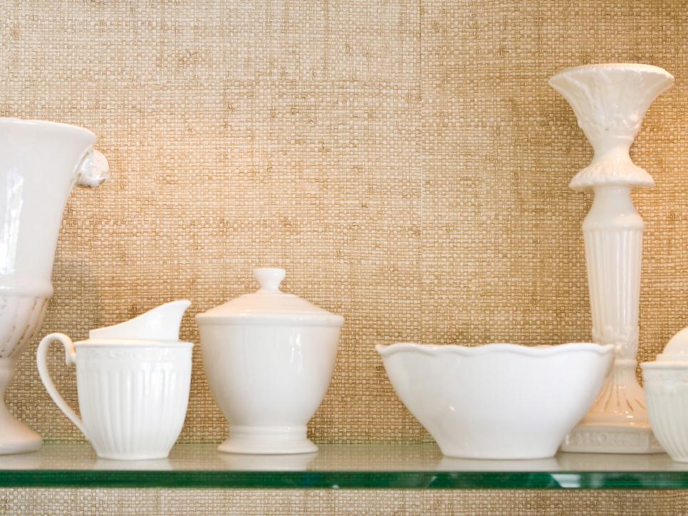 White China Displayed on Glass Shelf with Grasscloth Backdrop