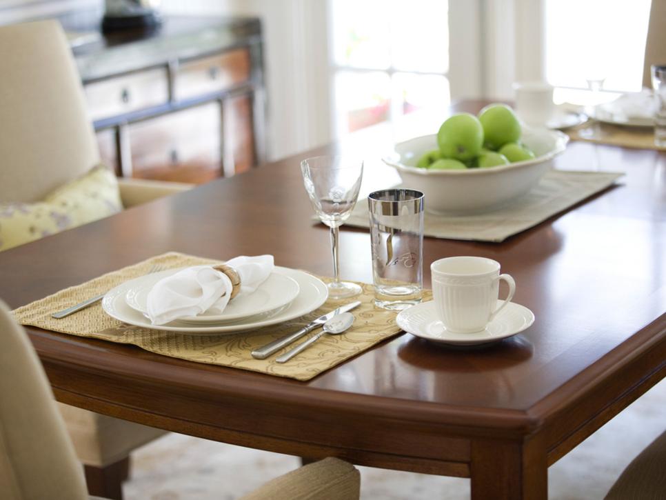 Upholstered Chairs and Wood Dining Table With Place Setting