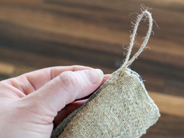 Hand sew a loop of twine, ribbon or string to heel side of stocking top.
