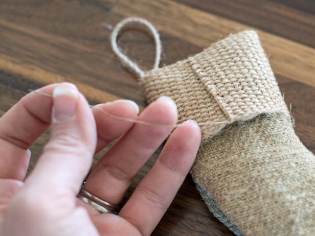 Cut length of trim that can completely wrap around stocking top and overlap by about 1/2" to create a decorative cuff. Hand stitch where cuff ends overlap and along stocking top.