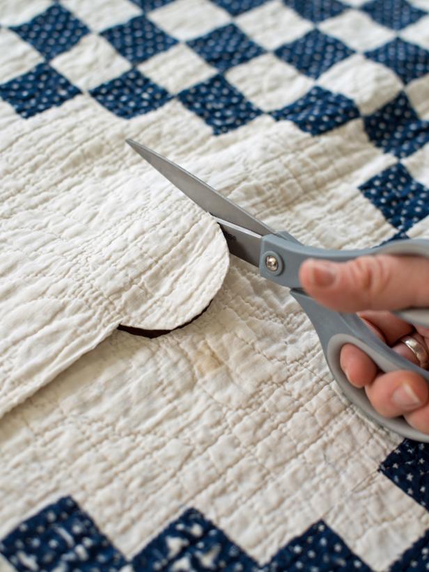 Find the center point of the tree skirt, then cut out a circular hole to allow for the tree trunk.
