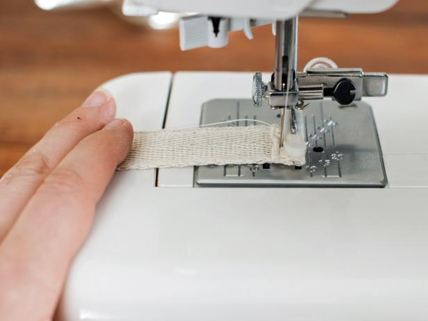 Cut a ribbon into eight 12" lengths. Fold one end of each ribbon over twice and stitch on sewing machine for a finished end.