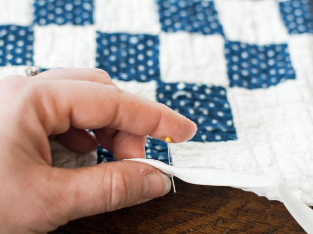 Wrap double-fold quilt binding around the raw edge of the quilt and pin in place.